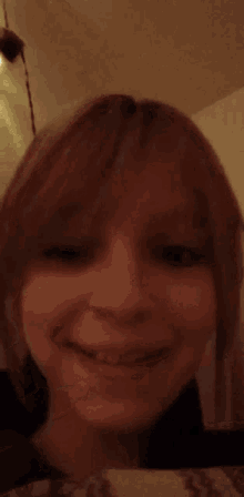 a close up of a woman 's face smiling
