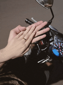 a person holding another person 's hand with a g shock watch in the background