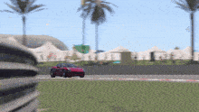 a red sports car is driving down a race track