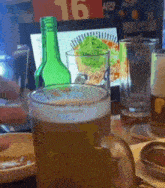 a bottle of beer sits next to a glass of beer