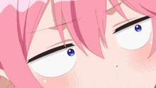 a close up of a girl with pink hair and blue eyes making a funny face