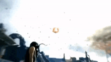 a group of people are standing in front of a large fireball flying through the air .