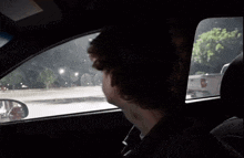 a man in a car with a sticker on the windshield that says ' airbag ' on it