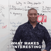 a man stands in front of a white board with the words " what makes it interesting " on it