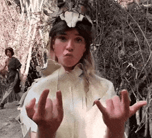 a woman with horns on her head is making a funny face