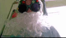 a person wearing a santa claus costume with a beard and sunglasses