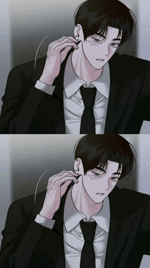 a man in a suit and tie is putting earrings in his ear