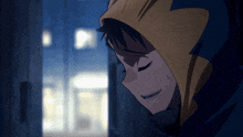 a man in a yellow and blue hoodie looks down