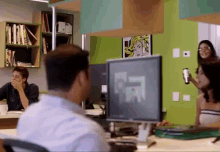 a man sits at a desk in front of a dell monitor