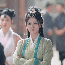 a woman in a green and blue costume with a crown on her head