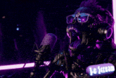 a skeleton wearing headphones and glasses sings into a microphone