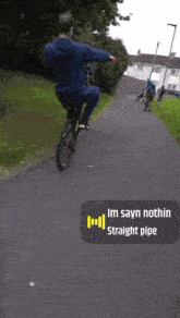 a man is riding a bike down a path with a sticker that says im sayn nothin straight pipe