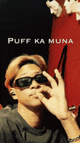 a man wearing sunglasses with the words puff ka muna on the bottom right