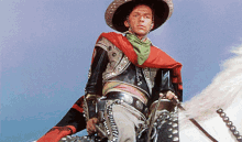 a man in a cowboy outfit is riding a horse