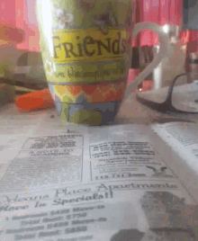 a cup that says friends on it is on a table