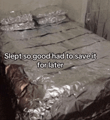 a bed that is covered in aluminum foil with the words slept so good had to save it for later