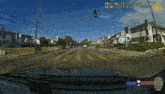 a car is driving down a street that has a sign that says kensington