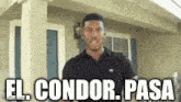a man is standing in front of a house with the words el condor pasa above him