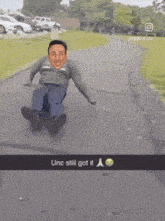 a snapchat of a man sliding down a road with the caption " unc still got it "