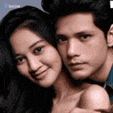 a man and woman are posing for a picture together .