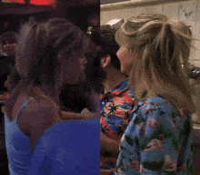 a man in a hawaiian shirt is talking to a woman in a blue tank top