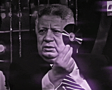 a man in a suit and tie holds a cd in his hand