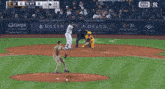 a man in a ny yankees uniform is walking on a field