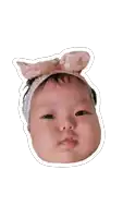 a baby wearing a headband with a pink bow on it