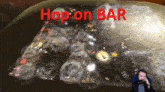 a man playing a video game with the words hop on bar in red