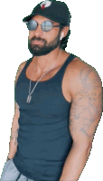 a man with a beard wearing a black tank top and a hat