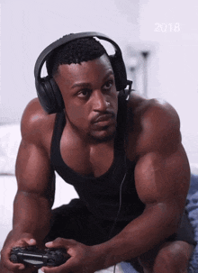 a man wearing headphones is playing a video game with the year 2018 on the bottom