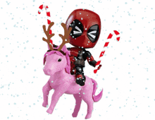 deadpool is riding on the back of a pink unicorn with merry xmas written on it