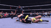 two women are wrestling in a ring with a referee and a sign that says nxt