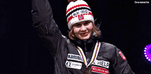 a woman wearing a hat and a medal that says help on it