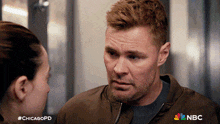 a man and a woman are looking at each other with the chicagopd written on the bottom