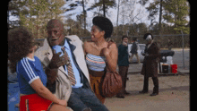 a man in a suit and tie is talking to a woman