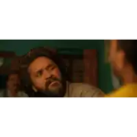 a man with a beard and a cross on his forehead is talking to another man