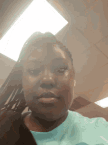 a woman wearing a blue shirt is making a funny face