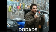 a man standing in front of a trash can with the word dodads on the bottom right