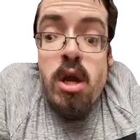 a man with glasses and a beard making a funny face