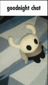 a stuffed animal laying on a bed with the words goodnight chat below it