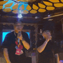 a close up of a person holding a microphone that says ' tnt ' on it