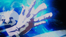 a person 's hand is reaching out towards something blue