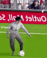 a man is kicking a soccer ball on a soccer field in front of a sign that says viggle.ai