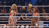 two women are standing in a wrestling ring with a sign that says aew on it
