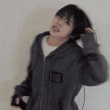 a blurry picture of a person wearing a grey hoodie