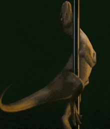 a statue of a dinosaur standing on a pole