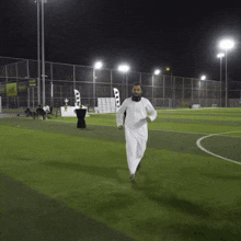 a man with a beard is running on a soccer field