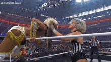 two women are wrestling in a ring with texas kings written on the side