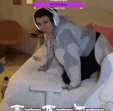 a man in a shark costume is playing a video game on a couch .